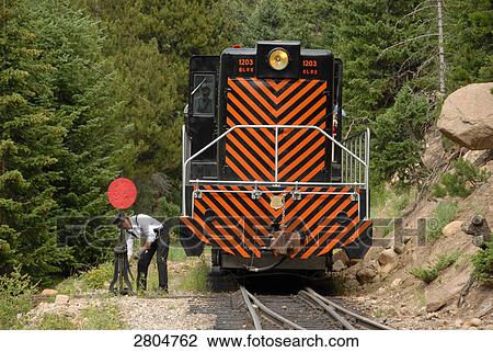 Stock Image - Driver pulling track lever near engine, Georgetown, Colorado, USA . Fotosearch