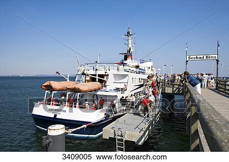 Stock Photography - Ferry and tourists at Binz pier, Ruegen, Germany . Fotosearch