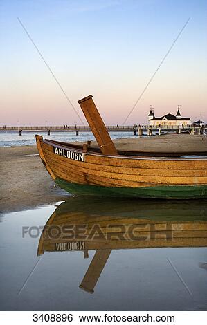 Fishing boat on the waterfront, Ahlbeck pier in the background, Usedom, Germany View Large Photo Image Stock Photograph - Fishing boat on the waterfront, Ahlbeck pier in the background, Usedom, Germany . Fotosearch