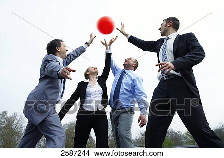 Picture - Four businesspeople playing with ball . Fotosearch