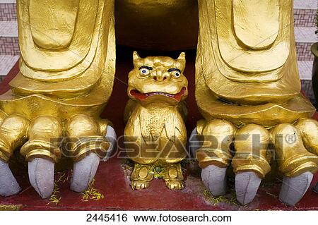 Stock Photograph - Golden lion guarding entrance to Sam Poh Temple . Fotosearch