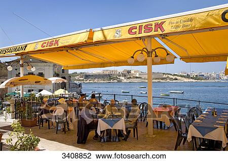 Group of people sitting in a restaurant at the coast, Valletta, Malta View Large Photo Image Stock Image - Group of people sitting in a restaurant at the coast, Valletta, Malta . Fotosearch