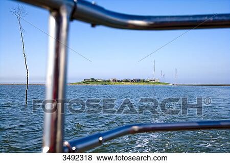 Stock Photo - Hallig Oland seen from a boat, Nordfriesland, Schleswig-Holstein, Germany . Fotosearch