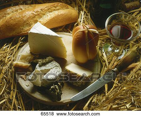 Stock Photo - High angle view of assorted cheese on cutting board . Fotosearch