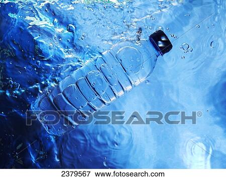 Stock Photo - High angle view of bottle in water . Fotosearch