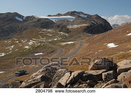 Stock Photo - High angle view of car on road, Yellowstone National Park, Wyoming, USA . Fotosearch