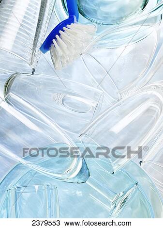 Stock Image - High angle view of champagne flutes and brush in water . Fotosearch
