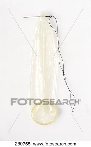 Stock Photography - High angle view of condom and needle . Fotosearch