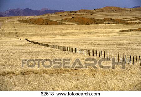 Stock Photo - High angle view of fence on field, Namib, southern Africa . Fotosearch