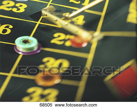 Stock Photography - High angle view of gambling chips on roulette table . Fotosearch