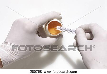 High angle view of person's hands holding thermometer and broken egg View Large Photo Image Stock Photo - High angle view of person's hands holding thermometer and broken egg . Fotosearch