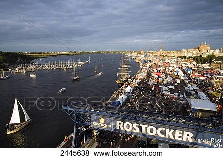 Stock Photo - High angle view of sailboats in sea during festival, Hanse Sail, Warnow, Rostock, Mecklenburg-West Pomerania, Germany . Fotosearch