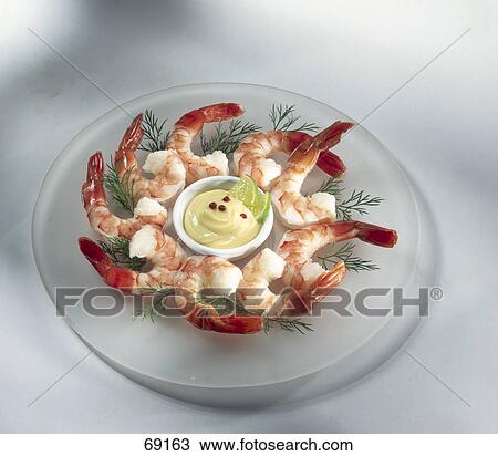 Stock Image - High angle view of shrimps and dill dip on plate . Fotosearch