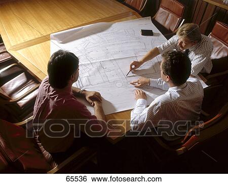 High angle view of three architects discussing blueprint View Large Photo Image Stock Photograph - High angle view of three architects discussing blueprint . Fotosearch