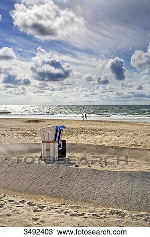 Stock Image - Hooded Beach Chair on the beach in Kampen, Sylt, Germany, elevated view . Fotosearch
