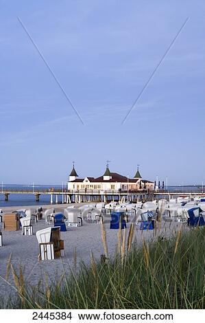 Hooded beach chairs on beach with pier in background, Ahlbeck, Usedom, Mecklenburg-West Pomerania, Germany View Large Photo Image Picture - Hooded beach chairs on beach with pier in background, Ahlbeck, Usedom, Mecklenburg-West Pomerania, Germany . Fotosearch