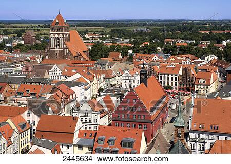 Picture - House and church in town, Greifswald, Mecklenburg-West Pomerania, Germany . Fotosearch