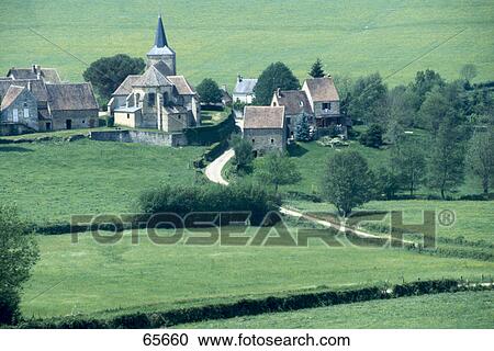 Stock Image - Houses and church on rural landscape, Burgundy, France . Fotosearch