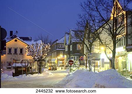 Stock Image - Houses lit up at dusk, Thueringer Wald, Thuringia, Germany . Fotosearch