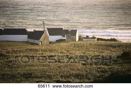 Stock Image - Houses on a hill overlooking the sea, Brittany, France . Fotosearch