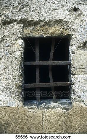 Stock Photograph - Iron bars of old dungeon cellar window . Fotosearch