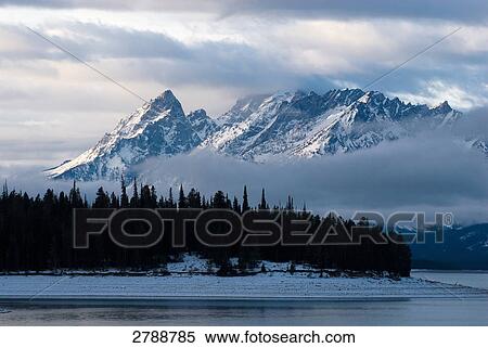 Stock Photography - Lake with mountain in background, Grand Teton National Park, Wyoming, USA . Fotosearch