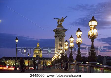 Stock Image - Lampposts and statues on bridge, Pont Alexandre III, Hotel Des Invalides, Paris, France . Fotosearch