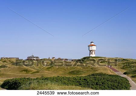 Stock Photo - Landscape with lighthouse in background, Langeoog, Lower Saxony, Germany . Fotosearch