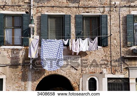 Laundry drying on a house facade, Venice, Italy View Large Photo Image Stock Photo - Laundry drying on a house facade, Venice, Italy . Fotosearch