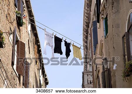 Laundry drying on clotheslines between two buildings, Venice, Italy, low angle view View Large Photo Image Stock Photo - Laundry drying on clotheslines between two buildings, Venice, Italy, low angle view . Fotosearch