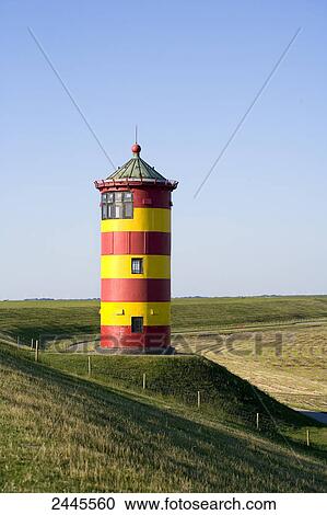 Stock Image - Lighthouse in field, Pilsum, Lower Saxony, Germany . Fotosearch