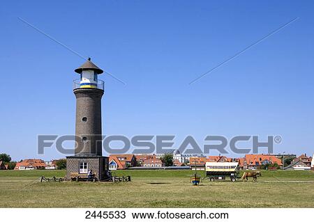 Lighthouse with buildings in background, East Frisian Islands, Lower Saxony, Germany View Large Photo Image Stock Image - Lighthouse with buildings in background, East Frisian Islands, Lower Saxony, Germany . Fotosearch