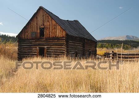 Stock Photography - Log cabin in field, Montana, USA . Fotosearch