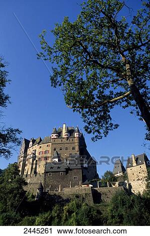 Stock Image - Low angle view of castle surrounded by forest, Eltz Castle, Rhineland-Palatinate, Germany . Fotosearch