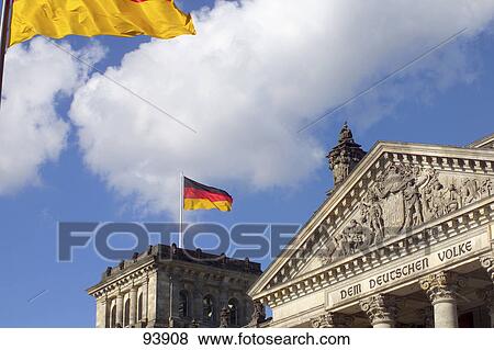Low angle view of German Flag fluttering on government building, Reichstag, Berlin, Germany View Large Photo Image Stock Photo - Low angle view of German Flag fluttering on government building, Reichstag, Berlin, Germany . Fotosearch