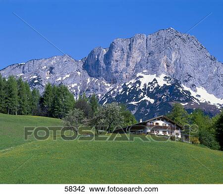 Stock Image - Low angle view of house on landscape . Fotosearch