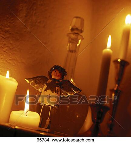 Picture - Low angle view of lit candles . Fotosearch