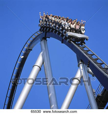 Low angle view of people riding on rollercoaster in amusement park View Large Photo Image Stock Image - Low angle view of people riding on rollercoaster in amusement park . Fotosearch