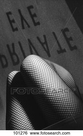 Stock Photograph - Low section view of woman wearing fish-net stocking . Fotosearch