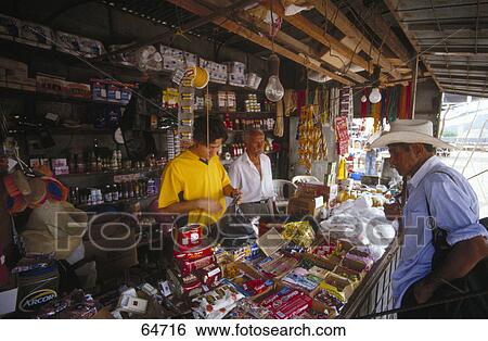 Male consumer and shopkeepers at store View Large Photo Image Stock Photograph - Male consumer and shopkeepers at store . Fotosearch