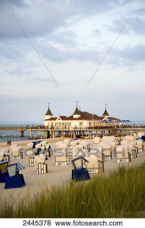 Marram grass and hooded beach chairs on beach with pier in background, Ahlbeck, Usedom, Mecklenburg-West Pomerania, Germany View Large Photo Image Stock Photo - Marram grass and hooded beach chairs on beach with pier in background, Ahlbeck, Usedom, Mecklenburg-West Pomerania, Germany . Fotosearch