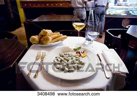 Meal with gnocchi in a restaurant Verona, Italy, elevated view View Large Photo Image Stock Photo - Meal with gnocchi in a restaurant Verona, Italy, elevated view . Fotosearch