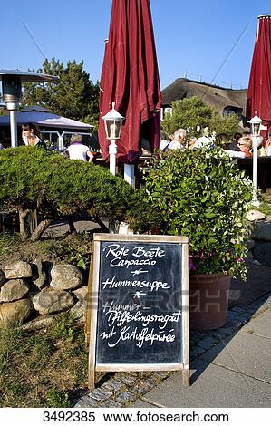 Stock Photography - Menu board in front of a restaurant, Stroenwai, Kampen, Sylt, Schleswig-Holstein, Germany . Fotosearch