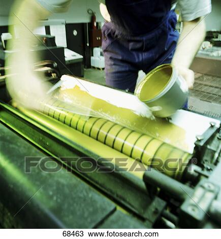 Stock Image - Mid section view of man working in printing press . Fotosearch