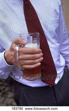 Stock Photography - Midsection view of a businessman holding a mug of beer . Fotosearch