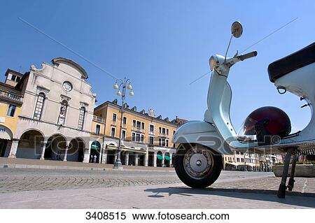 Stock Photography - Moped on a square in Belluno, Venetia, Italy, low angle view . Fotosearch