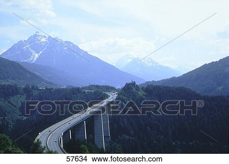 Picture - Motorway bridge through mountains . Fotosearch
