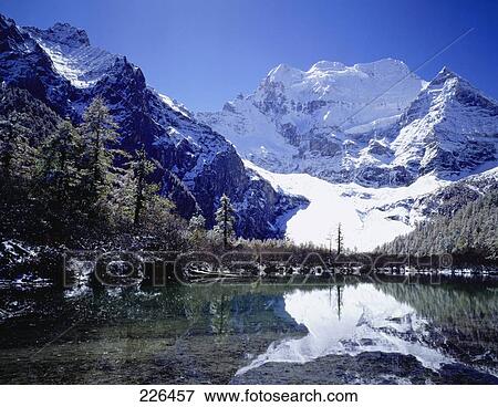 Stock Photo - Mountains reflected in lake, China . Fotosearch