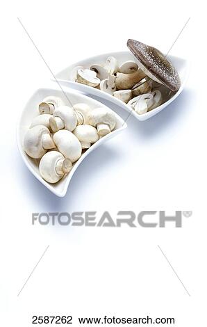 Stock Image - Mushrooms in a bowl, elevated view . Fotosearch