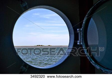 Stock Image - North Frisian Island seen from a porthole, Nordfriesland, Schleswig-Holstein, Germany . Fotosearch
